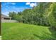The property boasts a spacious backyard with lush green grass and mature trees, offering privacy at 10252 Kristen Park Dr, Orlando, FL 32832