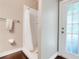 A simple bathroom with a shower, towel rack, and a door with window panels at 10252 Kristen Park Dr, Orlando, FL 32832