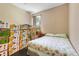 Spare bedroom cluttered with boxes, featuring a bed and natural light from the window at 10252 Kristen Park Dr, Orlando, FL 32832