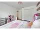 A bedroom with a pink kitchen, white walls, dark floors, and a closet at 10252 Kristen Park Dr, Orlando, FL 32832