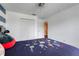 Well-lit bedroom featuring space-themed bedding, closet, and neutral paint at 10252 Kristen Park Dr, Orlando, FL 32832