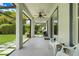 View of the covered patio featuring a ceiling fan, outdoor furniture, and stone paver walkway to the backyard at 10252 Kristen Park Dr, Orlando, FL 32832
