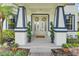 Welcoming front entrance with elegant double doors, decorative wreaths, and charming potted plants at 10252 Kristen Park Dr, Orlando, FL 32832