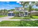Charming two-story home featuring a beautifully landscaped yard and a welcoming front porch at 10252 Kristen Park Dr, Orlando, FL 32832