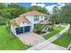 Lovely home featuring a manicured lawn, beautiful landscaping, and a spacious driveway leading to the garage at 10252 Kristen Park Dr, Orlando, FL 32832