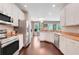 Bright kitchen with white cabinets, tan countertops, stainless appliances, and an eat-in space at 10252 Kristen Park Dr, Orlando, FL 32832