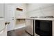Bright laundry room with modern washer and dryer, shelving, and convenient access to the outdoors at 10252 Kristen Park Dr, Orlando, FL 32832