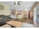 Open-concept living room with dark wood floors, neutral paint, and a view into the kitchen and dining area at 10252 Kristen Park Dr, Orlando, FL 32832