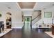 Open-concept living room showcases dark wood floors, an elegant staircase, and seamless access to other rooms at 10252 Kristen Park Dr, Orlando, FL 32832