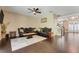 Elegant living room with dark wood floors, classic sofas, and access to the front entryway and staircase at 10252 Kristen Park Dr, Orlando, FL 32832