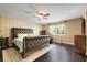 Main bedroom featuring a padded headboard, dark furniture, and a ceiling fan at 10252 Kristen Park Dr, Orlando, FL 32832