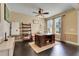 A cozy home office with dark wood floors, a ceiling fan, and multiple windows providing ample natural light at 10252 Kristen Park Dr, Orlando, FL 32832