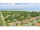 Aerial view showcasing the neighborhood's proximity to the lake, landscaping, and rooftops at 108 Stanton Estates Cir, Winter Garden, FL 34787