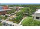 Aerial view of a charming town square featuring lush landscaping and brick-paved walkways, surrounded by attractive buildings at 108 Stanton Estates Cir, Winter Garden, FL 34787