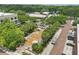Aerial view showcases a town square with lush greenery, brick walkways, and buildings with convenient parking at 108 Stanton Estates Cir, Winter Garden, FL 34787