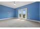 Spacious carpeted bedroom featuring a ceiling fan and french doors leading to a balcony at 108 Stanton Estates Cir, Winter Garden, FL 34787