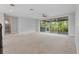 An expansive bonus room featuring large windows, carpet, and views of lush greenery at 108 Stanton Estates Cir, Winter Garden, FL 34787