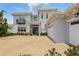 A picturesque home featuring an attached garage and paver driveway complemented by lush greenery at 108 Stanton Estates Cir, Winter Garden, FL 34787