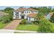 An upscale residence featuring well-manicured landscaping, paver driveway, and a two-car garage at 108 Stanton Estates Cir, Winter Garden, FL 34787