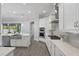 Bright, modern kitchen with a large island, stainless steel appliances, and backyard views at 108 Stanton Estates Cir, Winter Garden, FL 34787