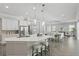Open-concept kitchen and dining area with pendant lighting, stainless appliances and island seating at 108 Stanton Estates Cir, Winter Garden, FL 34787