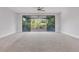 Open living room with large sliding doors leading to an outdoor balcony with ceiling fan at 108 Stanton Estates Cir, Winter Garden, FL 34787