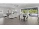 Bright living room with modern furniture and sliding doors to the backyard swimming pool at 108 Stanton Estates Cir, Winter Garden, FL 34787