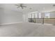 Bright loft area featuring a ceiling fan, iron railings, and multiple windows for natural light at 108 Stanton Estates Cir, Winter Garden, FL 34787