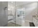 Sleek bathroom featuring dual vanities, glass shower, and modern finishes and access to bedroom at 108 Stanton Estates Cir, Winter Garden, FL 34787