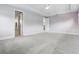 A large, light-filled main bedroom showcasing neutral walls, carpet, and trim, plus two entry points to other rooms at 108 Stanton Estates Cir, Winter Garden, FL 34787