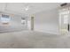 Spacious main bedroom with neutral colors, tray ceilings, carpet, and backyard views, plus access to other rooms at 108 Stanton Estates Cir, Winter Garden, FL 34787