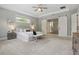 Large main bedroom with a view to the yard, tray ceiling, ceiling fan, and bathroom entrance at 108 Stanton Estates Cir, Winter Garden, FL 34787