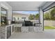Outdoor kitchen features stainless appliances, tile backsplash, and granite countertops at 108 Stanton Estates Cir, Winter Garden, FL 34787