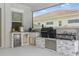 Outdoor kitchen featuring stainless steel appliances and granite countertops at 108 Stanton Estates Cir, Winter Garden, FL 34787