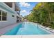 Beautiful backyard pool area with pristine water and lush tropical landscaping providing a private oasis at 108 Stanton Estates Cir, Winter Garden, FL 34787
