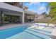 Swimming pool featuring lounge chairs and an outdoor kitchen at 108 Stanton Estates Cir, Winter Garden, FL 34787
