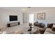 Modern living room boasts a TV, neutral decor, and tiled floors, creating a cozy atmosphere at 1119 Edith Dr, Daytona Beach, FL 32117