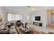 Bright living room features tile flooring, a plush sofa, a large window, and modern decor for a comfortable living space at 1119 Edith Dr, Daytona Beach, FL 32117