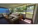 Inviting screened-in patio area with comfortable seating and a view of the lush backyard at 1119 Edith Dr, Daytona Beach, FL 32117