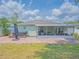Spacious backyard featuring a brick-paved patio with hot tub and covered screened-in porch at 12020 Philbrook Ct, Orlando, FL 32825