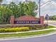 Brick entrance sign for Andover Lakes community with manicured landscaping and colorful flowers at 12020 Philbrook Ct, Orlando, FL 32825