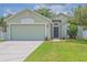 Charming single-story home with a well-manicured lawn and an attached two-car garage at 12020 Philbrook Ct, Orlando, FL 32825