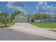 Exterior view of a single-story house with light green paint and a well-maintained lawn at 12020 Philbrook Ct, Orlando, FL 32825