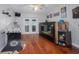 Spacious game room with hardwood floors, Super Chexx game, large fish tank, and double doors to outside at 12020 Philbrook Ct, Orlando, FL 32825