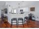 Stylish kitchen featuring a breakfast bar with seating, stainless steel appliances, and smooth wood flooring at 12020 Philbrook Ct, Orlando, FL 32825