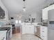 Bright kitchen with stainless steel appliances, white cabinetry and an opening to living area enhancing the open floor plan at 12020 Philbrook Ct, Orlando, FL 32825