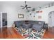 Cozy living room featuring hardwood floors, a sectional sofa, and stylish decor at 12020 Philbrook Ct, Orlando, FL 32825