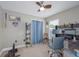 Neutral-toned office space features fan, shelving, two monitors, desk and window with blinds at 12020 Philbrook Ct, Orlando, FL 32825