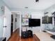 Bright office space features hardwood floors, shelving unit, light blue walls, and a mounted monitor at 12020 Philbrook Ct, Orlando, FL 32825