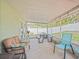 Relaxing screened-in porch featuring comfortable seating and a picnic table at 12020 Philbrook Ct, Orlando, FL 32825